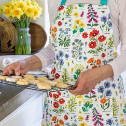 Wild Flowers Recycled Cotton Apron worn by adult holding baked goods