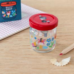 Glass jar pencil sharpener with fairies amongst flowers print on desk with pencil