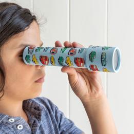 Child looking through kaleidoscope with print of vintage cars and other vehicles