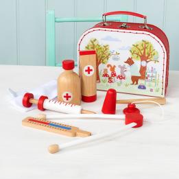 Woodland Friends wooden doctor's play set pieces on table with case