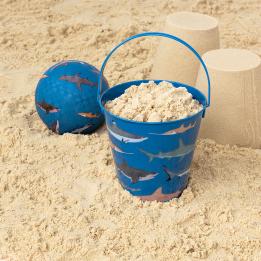 Sharks tin bucket containing sand alongside play ball and sandcastles