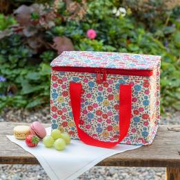 Tilde lunch bag outside on garden bench alongside macarons, strawberry and grapes