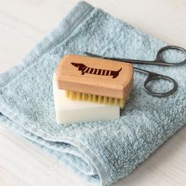 wooden nail brush featuring a sausage dog illustration