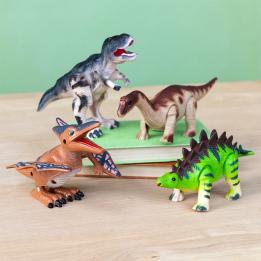 four dinosaurs - Pterodactyl , Stegosaurus, Tyrannosaurus rex and Brontosaurus side by side