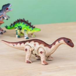 brown and beige Brontosaurus and a green stegosaurus in the back