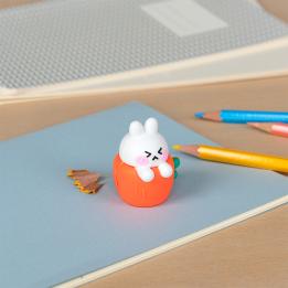 Rabbit-shaped pencil sharpener with coloured pencils placed beside