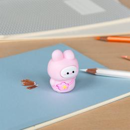 pink bunny shaped pencil sharpener with coloured pencils placed beside