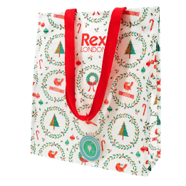 Festive Christmas design shopping bag with red handles and a tag 