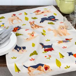 Cotton tea towel featuring an illustration of various dog breeds in playful poses