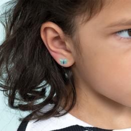 Stick-on earrings in butterfly shape on a kid’s ear