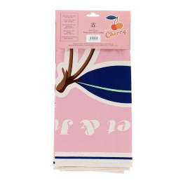 Cotton tea towel featuring a cherry print with pink background in a packaging