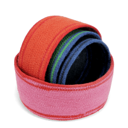 Four woven storage baskets in varying sizes and colours stacked