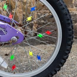 bicycle wheel with colourful lightning bolt-shaped spoke decorations