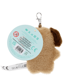 dog-shaped plush keyring wearing a tie with brown ears and a tag with safety warnings