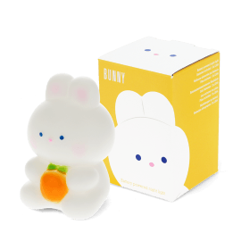 White bunny night light with an orange carrot, shown next to its yellow packaging box