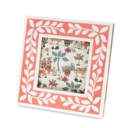 Square pink picture frame with white leaf patterns on the border.
