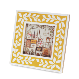 Square picture frame with white leaf patterns and mustard yellow colour on the border.