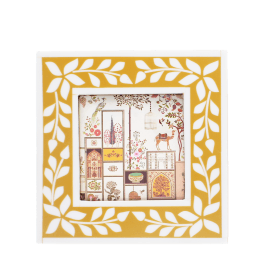 Square picture frame with white leaf patterns and mustard yellow colour on the border.