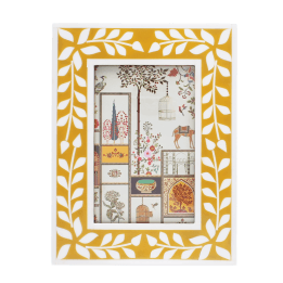 picture frame with a mustard yellow border and white leaf patterns