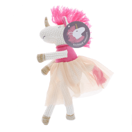 Knitted unicorn toy wearing a pink top and skirt with tag