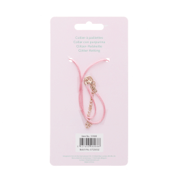 back of unicorn glitter necklace packaging with safey warnings in mulitliingual 