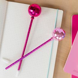 two dsico ball pens in pink placed on a notebook