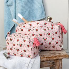 Rectangular bag in pale pink with a floral pattern of small red and green flowers