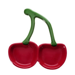 Red ceramic trinket dish shaped like two cherries with green stems.