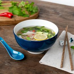 Blue ceramic noodle bowl set with spoon, chopsticks, and fish-shaped rest
