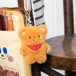 Light brown plush teddy bear keychain with a red polka-dotted bandana, metal clasp for attachment