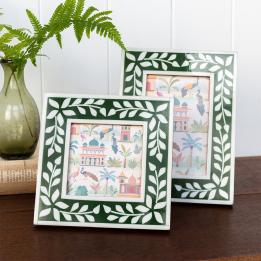 picture frame with a green border and white leaf patterns