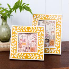 picture frame with a mustard yellow border and white leaf patterns