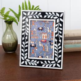 picture frame with a navy blue border and white leaf patterns