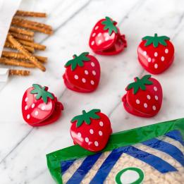 Six strawberry-shaped bag clips in red with green leaves