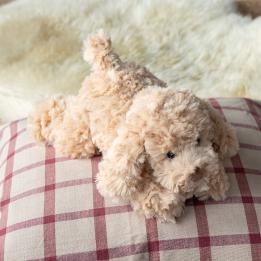 Light brown plush dog toy lying down with floppy ears and soft fur