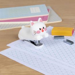 Kitten-shaped stapler with a small box of staples beside it