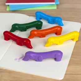 Set of six sausage dog-shaped crayons in yellow, purple, red, blue, green, and orange.