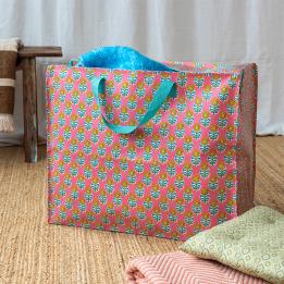 Pink jumbo storage bag with colourful floral designs.
