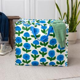 Large storage bag with a blue floral pattern and blue handles.