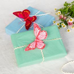 Two bright pink butterfly clip‑on decorations.