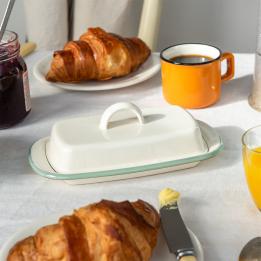 Rectangular white enamel butter dish with a pistachio green rim and a handled lid.