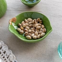 Green ceramic bowl with textured surface and a leaf design near the rim with brown stem accent