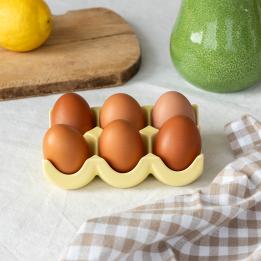Yellow ceramic egg holder displayed with six eggs