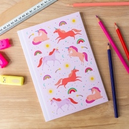 Pink notebook with colourful unicorns, rainbows, stars, and suns on the cover.