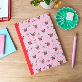 Pink notebook with a french rose design on the cover.
