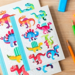 Notebook with colourful dinosaurs on a light background.