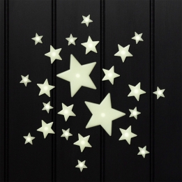 Glow‑in‑the‑dark star shapes in different sizes on a black background.