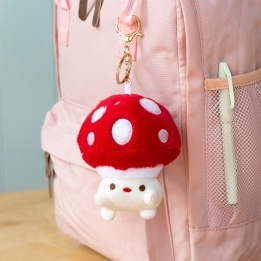 Plush mushroom bag charm with red spotted cap, gold keyring and soft white base
