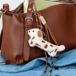 Plush sausage dog bag charm with brown spots, cord strap and clip.