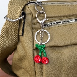 Cherry keyring with green stems and silver ring and clip attachment.